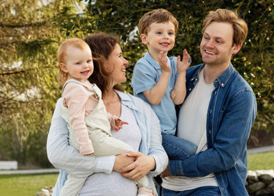 A family outdoors together in a natural setting on the north-west coast of Norway.