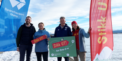 Beachflagg Sparebanken Møre og Stikkut, og representater fra de to som holder Stikkut-plakater
